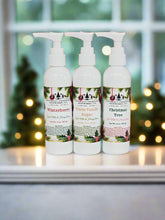 Three white bottles with floral labels on a red and white striped background