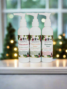 Three white bottles with floral labels on a red and white striped background